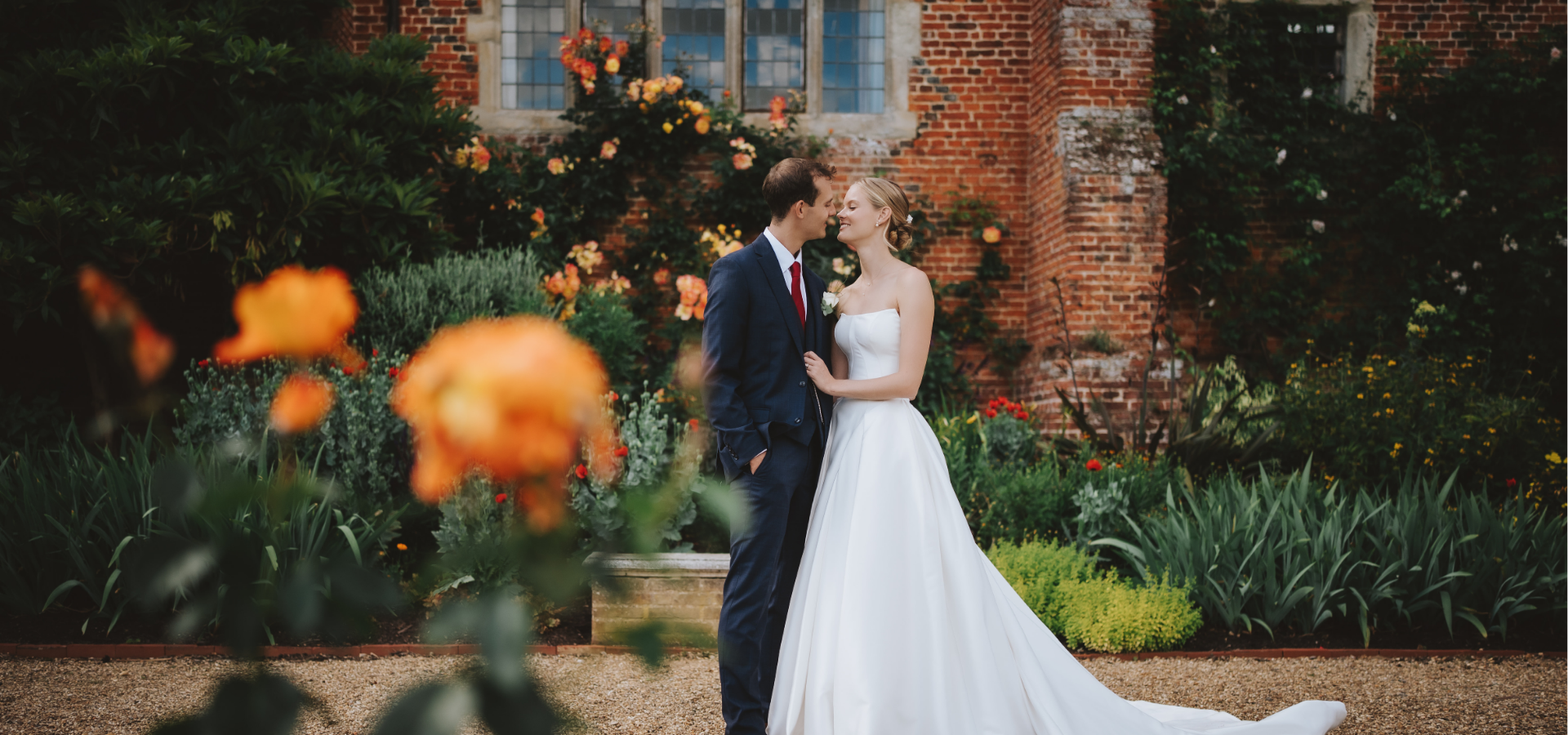 Bride and Groom having photos in the garden at Layer Marney Tower